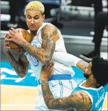  ?? Chris Carlson Associated Press ?? KYLE KUZMA, pulling a rebound away from Charlotte’s Miles Bridges, led the Lakers with 24 points against the Hornets.