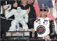  ?? NICK WASS — THE ASSOCIATED PRESS ?? Kevin Harvick poses with the trophy in Victory Lane after winning May 6 at Dover Internatio­nal Speedway.