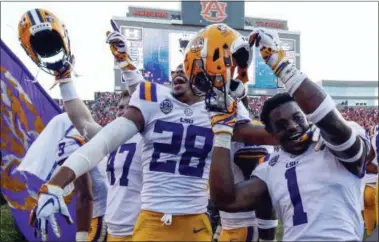  ?? BUTCH DILL — THE ASSOCIATED PRESS ?? LSU players celebrate after they defeated Auburn, 22-21, on a last-second field goal on Sept. 15.