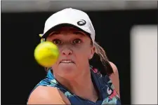  ?? ALESSANDRA TARANTINO/AP PHOTO ?? Poland’s Iga Swiatek returns the ball to Turkey’s Ons Jabeur during their final match at the Italian Open on Sunday in Rome.