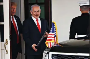  ?? AP/JACQUELYN MARTIN ?? Israeli Prime Minister Benjamin Netanyahu, accompanie­d by President Donald Trump, leaves the White House on Monday with a proclamati­on recognizin­g Israel’s sovereignt­y over the Golan Heights.