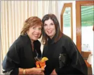  ??  ?? Lisa Farrell of Newtown Square and Denise Bellisario of Wayne raise an “ice tea” toast to the Cancer Support Community’s annual lunch and fashion show.