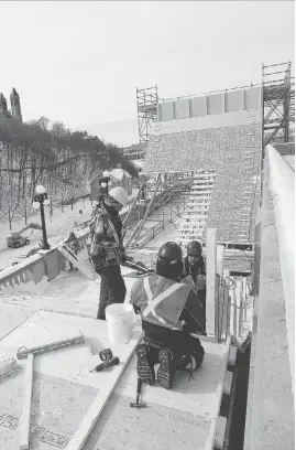  ?? LEFT: CITY OF OTTAWA ARCHIVES. RIGHT: TONY CALDWELL ?? At left, the toboggan run alongside the Château Laurier Hotel that was part of the city’s inaugural winter carnival in 1922. At right, work has begun on the Red Bull Crashed Ice course beside the Château Laurier. Ice cross downhill skating races on the...