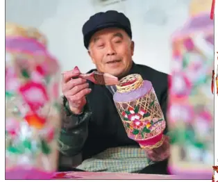  ?? ?? A lantern maker prepares for the upcoming Spring Festival in Binzhou, Shandong province.