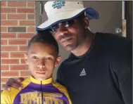  ?? (Submitted photo) ?? CJ Smith (left), shown with his father St. Francis Smith at the Junior Olympics track and field meet in 2015, is now being recruited by Arkansas as a wide receiver.