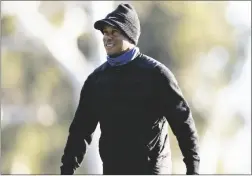  ?? RYAN KANG VIA AP ?? TIGER WOODS WALKS OFF THE FIFTH GREEN during the pro-am of the Genesis Invitation­al golf tournament at Riviera Country Club on Wednesday in the Pacific Palisades area of Los Angeles.