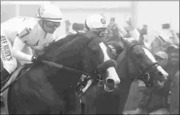  ?? BARBARA D. LIVINGSTON ?? Good Magic (right) pressed Justify through solid fractions in the Preakness before finishing fourth.