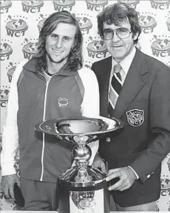  ?? World Championsh­ip Tennis ?? TRANSFORME­D TENNIS Bjorn Borg, left, and Mike Davies. Davies introduced optic yellow balls for
better TV visibility, colorful clothing, pro tours and big jackpots.