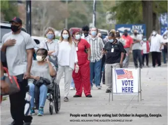  ?? MICHAEL HOLAHAN/THE AUGUSTA CHRONICLE VIA AP ?? People wait for early voting last October in Augusta, Georgia.