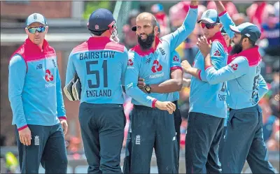 ??  ?? Moeen Ali (centre) in celebrator­y mood earlier this month