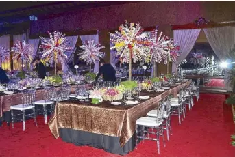  ??  ?? The table setting at the state dinner in honor of President Obama depicts the theme “harvest” (top). Bright floral arrangemen­ts adorn the tables for a luncheon in honor of Japanese Prime Minister Shinzo Abe in July 2013 (above). The men who deck the halls (right): Jun Mugado (seated) with his team (from left) Rene Sumalinog, Nick Reza, Jeremy Escobido, and Ramil Atencio.