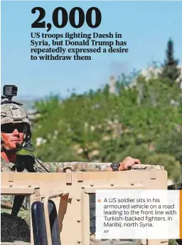  ?? AP ?? A US soldier sits in his armoured vehicle on a road leading to the front line with Turkish-backed fighters, in Manbij, north Syria.