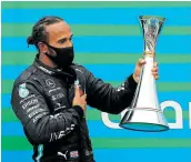  ?? Picture: LEONHARD FOEGER/GETTY IMAGES ?? SIGN OF THE TIMES: Lewis Hamilton on the podium after winning the Grand Prix in Hungary.