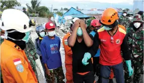  ?? (Jorge Silva/Reuters) ?? A MAN REACTS yesterday after identifyin­g a relative’s body found in the rubble of a destroyed mosque hit by the earthquake in Palu, on the Indonesian island of Sulawesi.