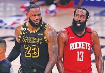  ?? MARK J. TERRILL/ASSOCIATED PRES ?? LeBron James of the Los Angeles Lakers and James Harden of the Houston Rockets react to an official’s call during the second half of a Western Conference semifinal Sunday in Lake Buena Vista, Fla.
