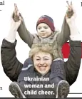  ??  ?? Ukrainian woman and child cheer.