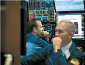  ?? MICHAEL NAGLE/BLOOMBERG NEWS ?? Traders on the floor of the New York Stock Exchange watch the losses cascade across their screens Monday.