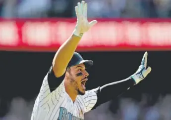  ??  ?? Rockies third baseman Nolan Arenado celebrates hitting a walk-off home run in the ninth inning Sunday against the San Francisco Giants at Coors Field. Matthew Stockman, Getty Images