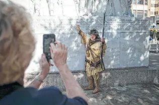  ?? Josie Norris / San Antonio Express-News ?? David Crockett of Bay City points to his ancestor’s name, which is engraved on the Cenotaph.