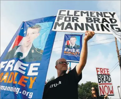  ?? JOSE LUIS MAGANA / ASSOCIATED PRESS ?? Supporters of Bradley Manning hold up banners as they protest in Fort Meade, Maryland, on Wednesday before he was sentenced. Manning received a lengthy prison sentence and will be dishonorab­ly discharged from the US military.