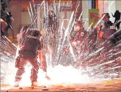  ?? AFP ?? A firecracke­r thrown by protesters explodes near the White House during a protest over the death of George Floyd.