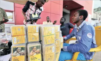  ??  ?? SIM card sellers for MTN wait for customers at a roadside kiosk in Lagos, Nigeria. MTN is facing a second fine in Nigeria on allegation­s that it illegally moved more than $14 billion (R194bn) from that country. FILE PHOTO: BLOOMBERG