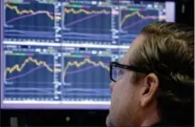  ?? RICHARD DREW — THE ASSOCIATED PRESS ?? Specialist Gregg Maloney works at his post on the floor of the New York Stock Exchange, Monday.