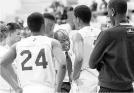  ?? JUSTIN GREEN/OS STRINGER ?? Coach Billy Owens huddles with his University High basketball team during a timeout in a 2012 game against Oak Ridge. Owens had been an Oak Ridge basketball assistant for four years but is now the Pioneers head football coach.