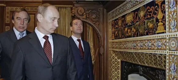  ?? THE NEW YORK TIMES FILE PHOTO ?? Russian leaders Vladimir Putin, centre, and Dmitry Medvedev, right, with cellist Sergei Roldugin in 2009. Roldugin, a friend of Putin, has been linked to several offshore companies.