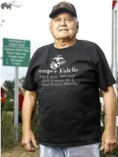  ?? STAFF PHOTO BY TROY STOLT ?? Vietnam War Veteran Aubie Camp stands for a portrait in front of a sign that reads “Hometown of Aubie Camp, Vietnam 1965-1966, Silver Star and Purple Heart recipient, U.S.M.C” after a ceremony to celebrate the sign being put up by the city of Apison and members of his high school class in September.