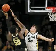  ?? CHARLIE NEIBERGALL — THE ASSOCIATED PRESS ?? Purdue forward Trevion Williams shoots over Iowa center Luka Garza, right, during the second half of an NCAA college basketball game March 3in Iowa City, Iowa.