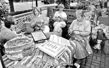  ?? Bob Donaldson/Post-Gazette ?? A group women gather at the Sewickley Library to crochet strips from plastic newspaper and shopping bags into plastic mats to be used for sleeping on the ground by needy people and for soldiers to use as mini-mats. Among them are, from left, Joanne...