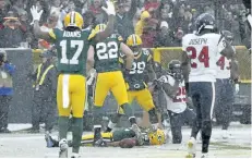  ?? THE ASSOCIATED PRESS FILES ?? Green Bay Packers’ Randall Cobb makes a snow angel after catching a touchdown pass during a Dec. 4 game against the Houston Texans, in Green Bay, Wis. The NFL wants to put some flair back into celebratio­ns, allowing players to use the football as a...