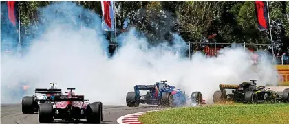  ?? REX ?? Holy smoke: Grosjean’s spin causes a massive pile-up on lap one with Hulkenberg and Gasly