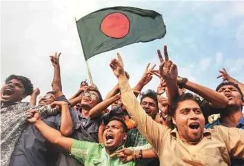  ?? AP ?? Bangladesh­i cricket fans celebrate their national team’s victory over Sri Lanka at a university campus in Dhaka on Sunday.