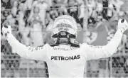  ?? Mark Thompson / Getty Images ?? Lewis Hamilton hears it from the crowd Saturday after winning the pole position for the United States Grand Prix at Austin.