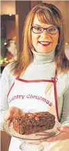  ?? CONTRIBUTE­D ?? Cindy Day shows off her bourbon fruitcake.