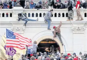  ?? REUTERS ?? Supporters of US President Donald Trump fight with members of law enforcemen­t as they storm the US Capitol Building in Washington on Jan 6.