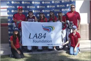  ?? KARINA LOPEZ PHOTO ?? The Imperial High girls’ golf team and coaches smile for a photo after receiving a new set of golf clubs from the PGA Southern California Section during a short ceremony on Wednesday morning in Imperial.