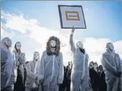  ?? AFP ?? Protestors dressed in white carry placards as they take part in a demonstrat­ion in Lyon to mark the Internatio­nal Day for the Eliminatio­n of violence against Women.