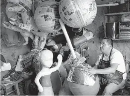  ?? LUIS ANTONIO ROJAS THE NEW YORK TIMES ?? Ivan Mena Álvarez is a piñata maker whose great-grandparen­ts owned one of the first shops in the Mexico City neighborho­od of Cuauhtémoc.