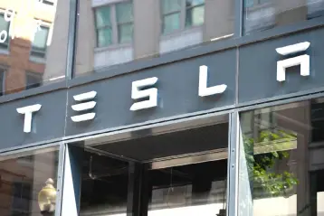  ??  ?? In this file photo, the Tesla logo is seen outside of their showroom in Washington, DC. Tesla CEO Elon Musk said in a blog posting Friday, August 24, that his company would continue to be publicly traded, weeks after suggesting that he would take the electric carmaker private. — AFP photo