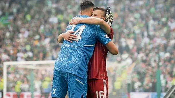  ?? ?? WARM EMBRACE: Midfielder Ylber Ramadani and goalie Kelle Roos at full-time of Aberdeen’s final game of the season, a 5-0 defeat to Celtic.