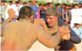  ??  ?? Pakistani immigrant workers in the United Arab Emirates take part in a Kushti competitio­n in Dubai.