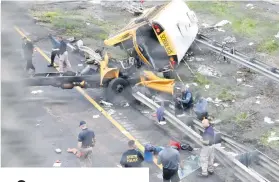  ?? Picture: Reuters ?? The wreckage of a school bus on Interstate 80 after an accident with a dump truck in New Jersey, US, this week.