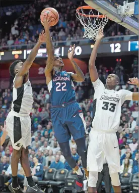  ?? JOHN WOIKE/HARTFORD COURANT/AP PHOTO ?? UConn’s Terry Larrier (22) splits the defense of Providence’s Rodney Bullock (5) and center Dajour Dickens (33) during the first half of Wednesday night’s exhibition game at Mohegan Sun Arena. Providence won 90-76.