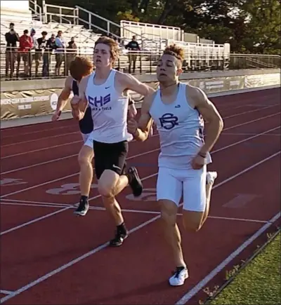  ?? Photo by Stephen Mazzone / OceanState­Running.com ?? In his first race since winning the 600-meter title at New Englands in early March, St. Raphael All-American Darius Kipyego, right, edged out Classical All-American Conor Murphy, center, in an 800-meter time trial Sunday night at Providence College.