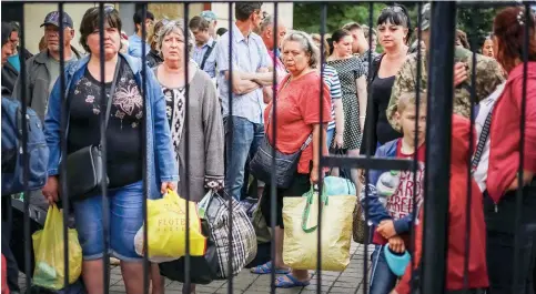  ?? Photo: Reuters ?? Evacuees wait to board a train in Ukraine, where the war is projected to displace up to 7 million people internally and a further 5 million abroad.