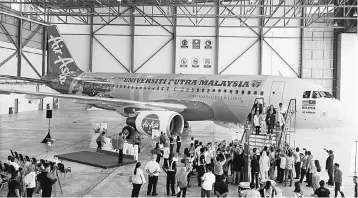  ?? — Bernama photo. ?? The livery depicting the words “Universiti Putra Malaysia”, its motto “With Knowledge We Serve” and icon, a rain tree designed by its Faculty of Design and Architectu­re were painted on AirAsia’s Airbus A320-200 aircraft with the registrati­on number...