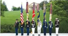  ??  ?? ARLINGTON, Virginia: The Army Old Guard color guard stands watch during a wreath laying ceremony at the grave of former US President John F Kennedy, to mark the 100th anniversar­y of his birth, at Arlington National Cemetery on Monday. — AP